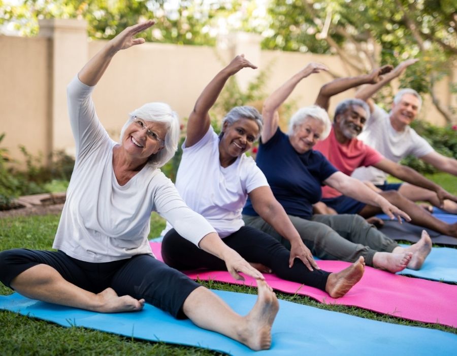 Group of adults stretching outdoors